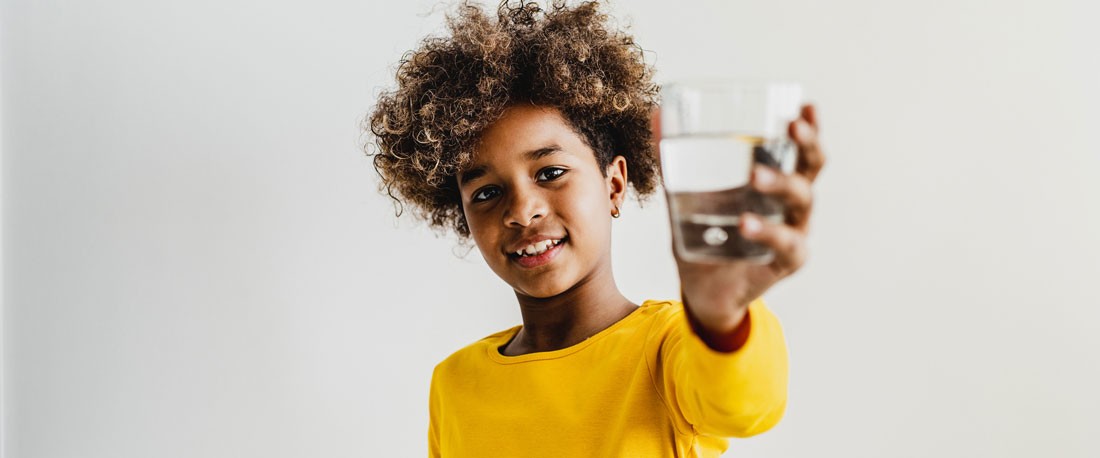 Child Holding Glass of Water
