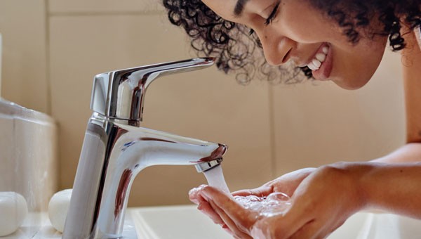 Woman Drinking Water From Tap