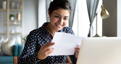 Woman Reading Paper Bill