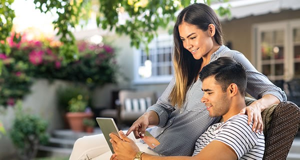 Couple Holding Tablet